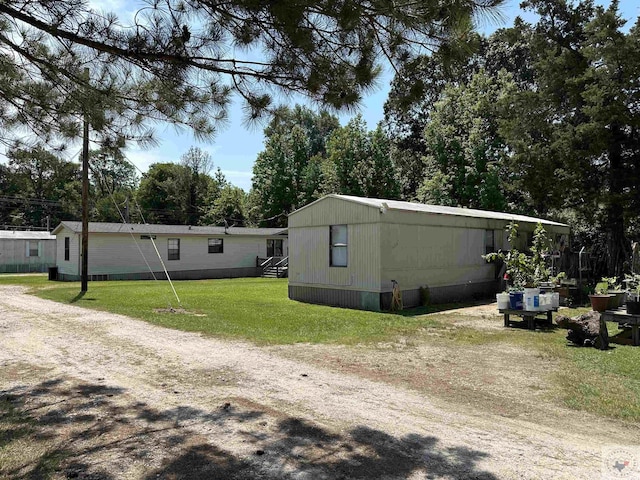 view of side of home featuring a yard