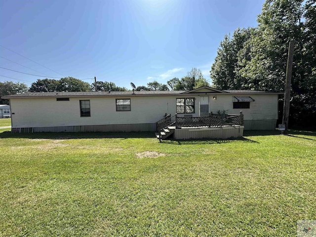 back of house with a lawn