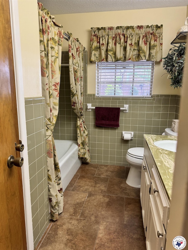 3905 Colorado St, Texarkana, TX 75503 - bathroom featuring tile walls, vanity, shower / bath combination with curtain, toilet, and a wainscoted wall