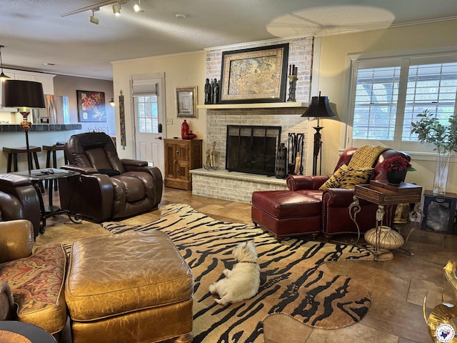 3905 Colorado St, Texarkana, TX 75503 - living area with crown molding, a brick fireplace, and track lighting