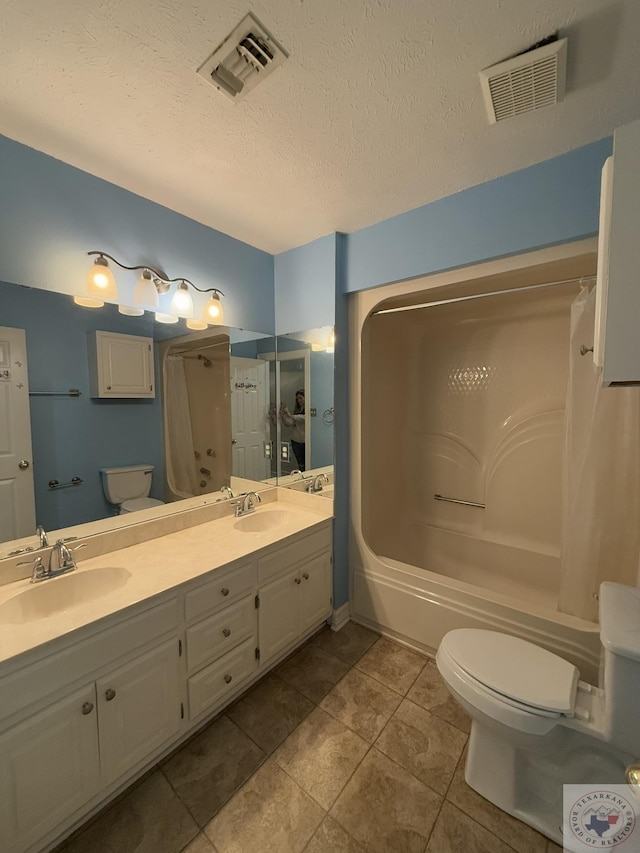 full bathroom with toilet, a textured ceiling, tile patterned floors, vanity, and shower / washtub combination