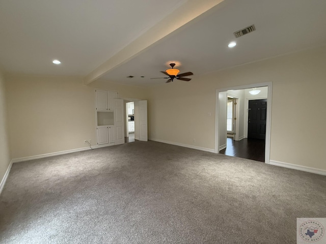 unfurnished living room with ceiling fan, dark carpet, and beam ceiling