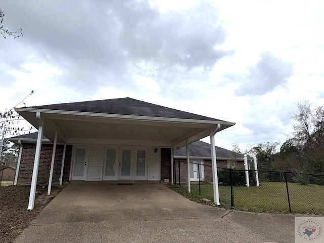 exterior space featuring a lawn and a carport