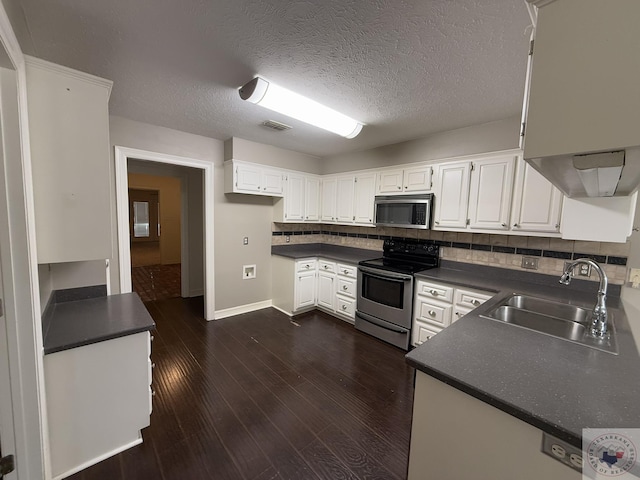 kitchen with white cabinets, appliances with stainless steel finishes, sink, and tasteful backsplash