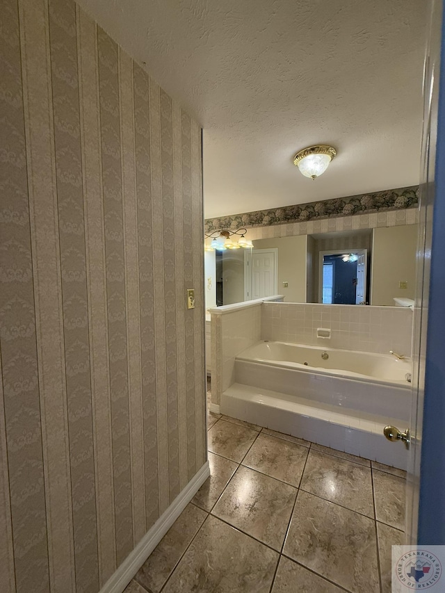 bathroom featuring a washtub, a textured ceiling, and tile patterned floors