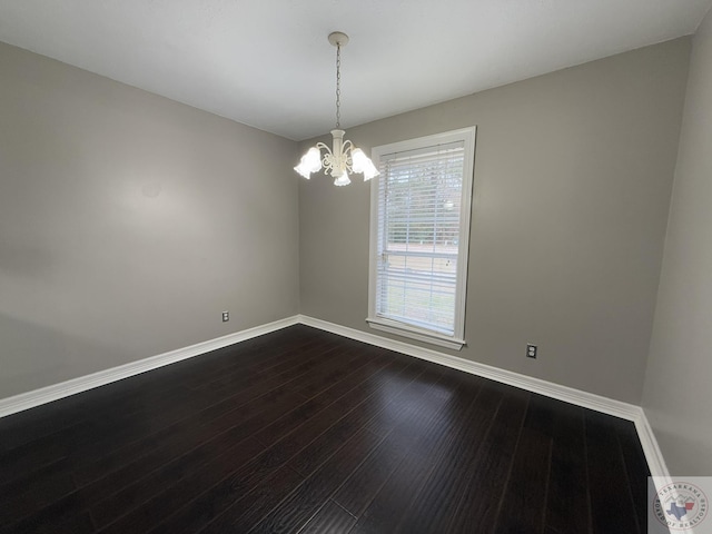 unfurnished room with hardwood / wood-style floors and a chandelier