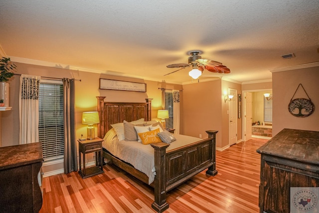 bedroom with crown molding, light hardwood / wood-style flooring, connected bathroom, and ceiling fan