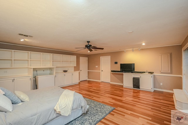 bedroom with crown molding, light hardwood / wood-style floors, beverage cooler, and ceiling fan