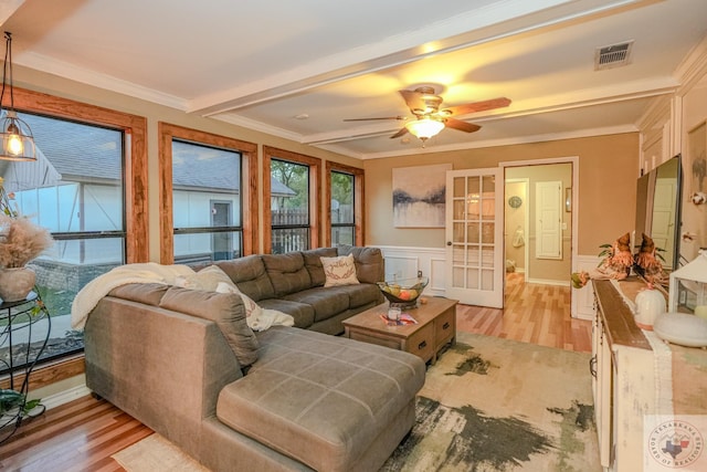 living room with crown molding, light wood-type flooring, and ceiling fan