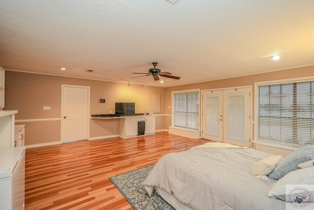 bedroom featuring ceiling fan, beverage cooler, light hardwood / wood-style flooring, and crown molding