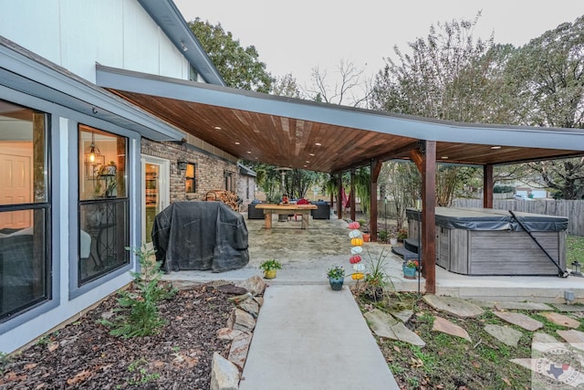 view of patio / terrace featuring a hot tub and area for grilling