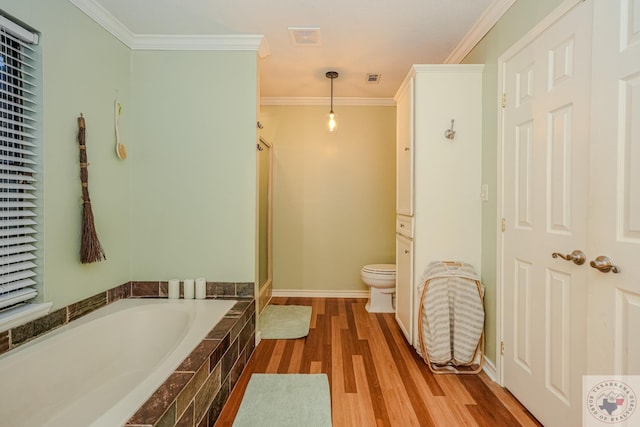 bathroom featuring wood-type flooring, toilet, ornamental molding, and shower with separate bathtub