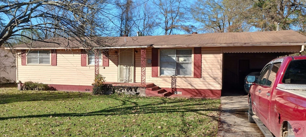 single story home with a front lawn and a carport