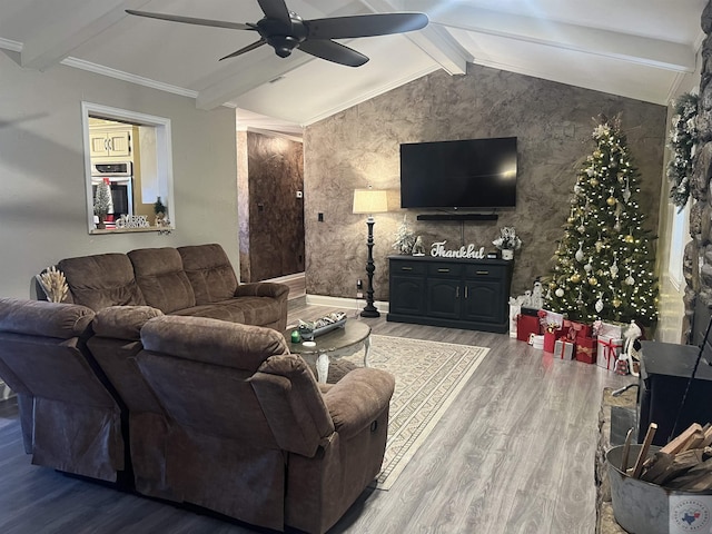 living room featuring hardwood / wood-style flooring, vaulted ceiling with beams, ceiling fan, and ornamental molding