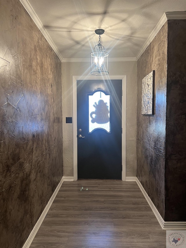 doorway to outside featuring a chandelier, ornamental molding, and dark wood-type flooring