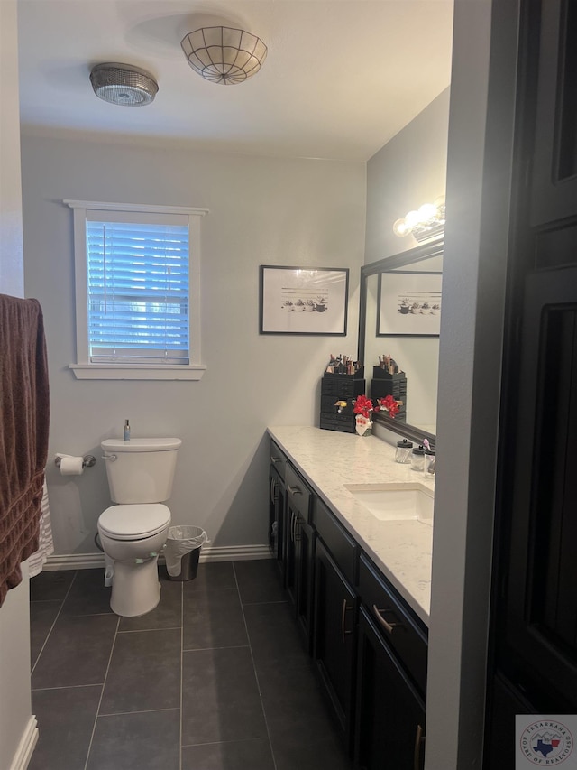 bathroom with vanity, toilet, and tile patterned floors