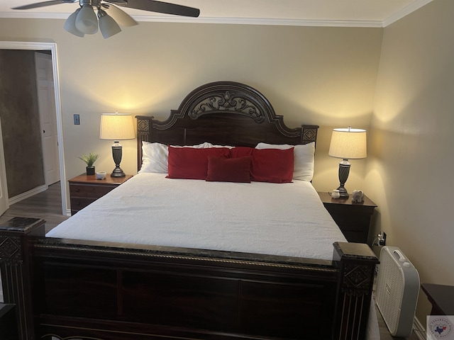 bedroom featuring dark hardwood / wood-style floors, ceiling fan, and ornamental molding