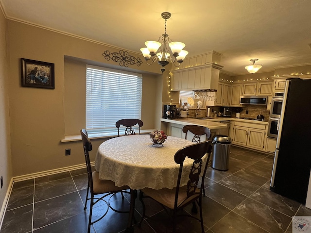 dining space featuring sink, a notable chandelier, and ornamental molding