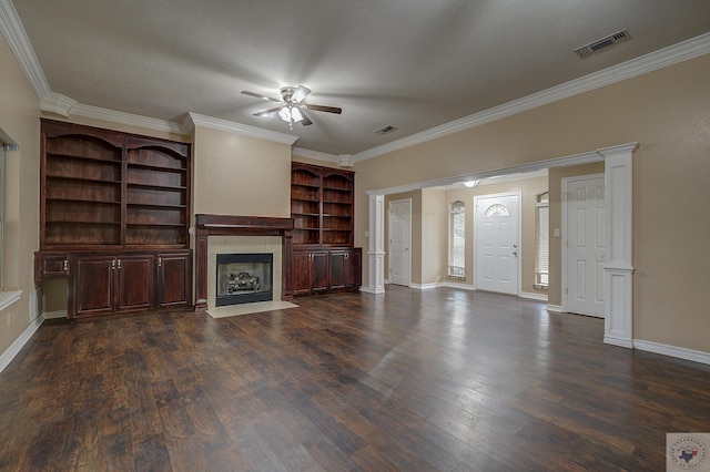 unfurnished living room with a tile fireplace, ornamental molding, ceiling fan, and dark hardwood / wood-style flooring