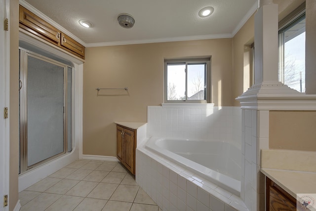 bathroom with tile patterned flooring, vanity, ornamental molding, and separate shower and tub