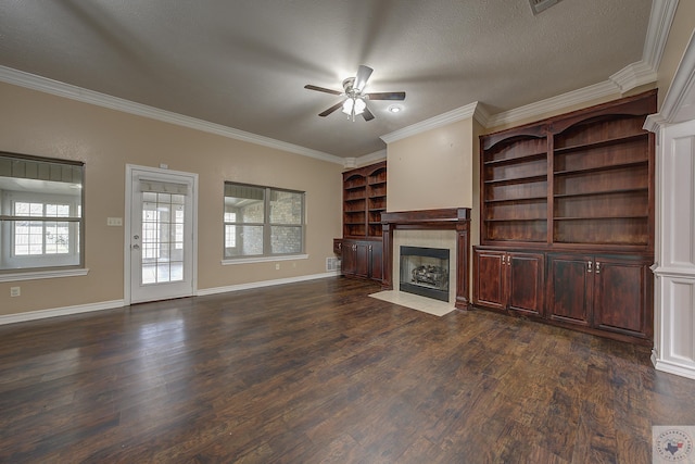 unfurnished living room featuring dark wood-type flooring, crown molding, a textured ceiling, ceiling fan, and a fireplace