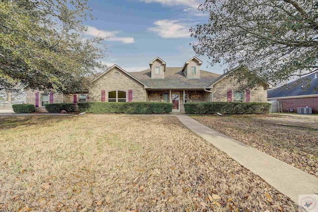 view of front of home featuring central AC and a front lawn