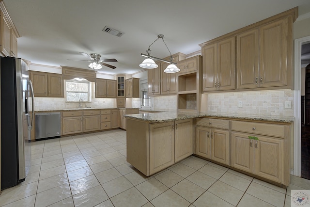 kitchen featuring appliances with stainless steel finishes, pendant lighting, light brown cabinetry, and kitchen peninsula