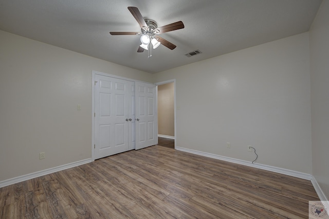 unfurnished bedroom with hardwood / wood-style flooring and ceiling fan