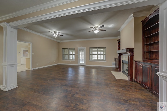unfurnished living room with decorative columns, ornamental molding, dark hardwood / wood-style floors, and ceiling fan