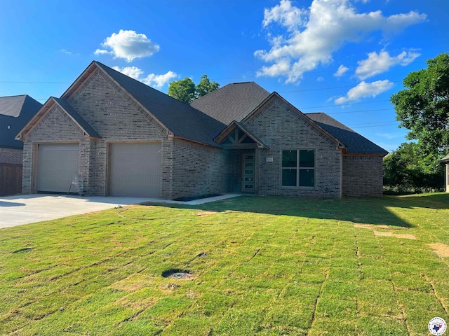5614 Deaton Pl, Texarkana, TX 75503 - view of front of property with brick siding, a garage, driveway, and a front lawn