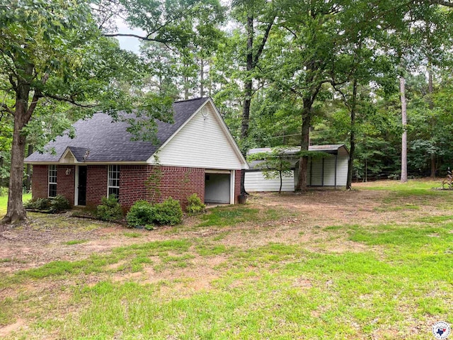 19 Hidden Valley Rd, Texarkana, TX 75501 - view of side of property with a carport, brick siding, a shingled roof, and a yard