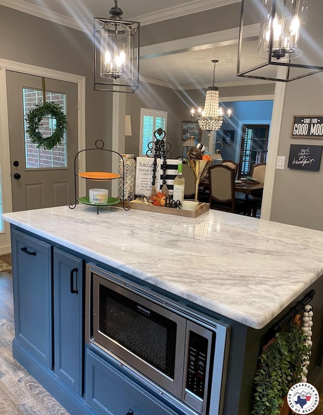 19 Hidden Valley Rd, Texarkana, TX 75501 - kitchen with a chandelier, stainless steel microwave, ornamental molding, light stone counters, and wood finished floors