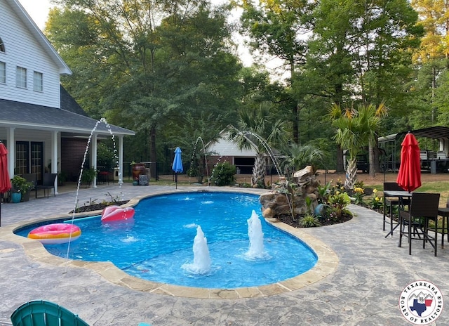 19 Hidden Valley Rd, Texarkana, TX 75501 - swimming pool with a patio and view of wooded area