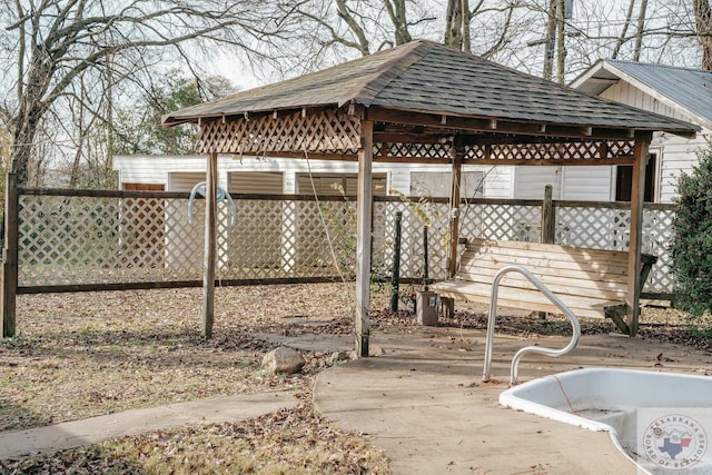 wooden terrace featuring a gazebo