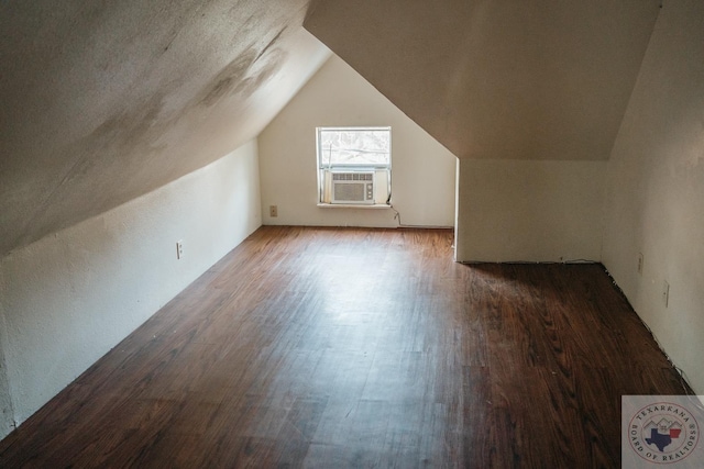 bonus room featuring cooling unit, hardwood / wood-style floors, and lofted ceiling