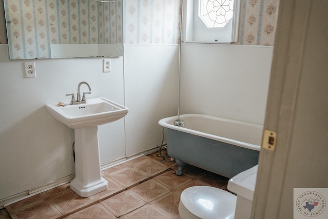 bathroom featuring toilet and a tub