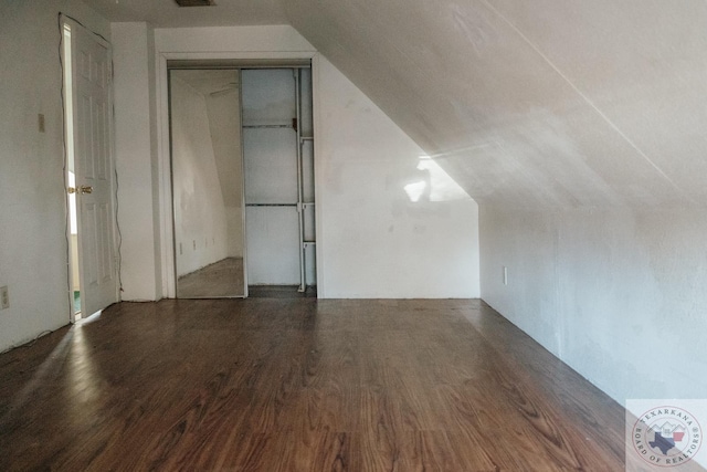 bonus room with vaulted ceiling and dark hardwood / wood-style flooring