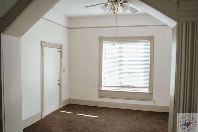 interior space featuring ceiling fan, multiple windows, and carpet