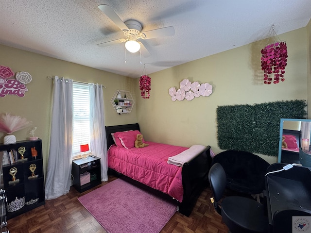 bedroom with ceiling fan and a textured ceiling