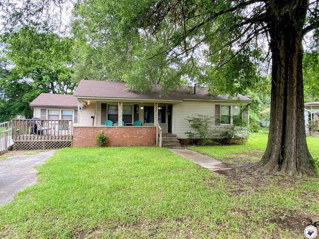 203 Patterson St, Naples, TX 75568 - ranch-style house with a porch and a front lawn
