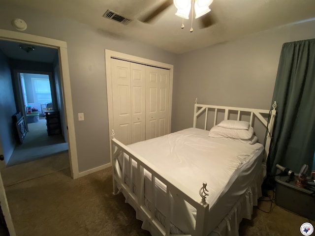 203 Patterson St, Naples, TX 75568 - bedroom with dark carpet, a closet, and a ceiling fan