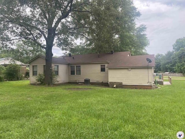 203 Patterson St, Naples, TX 75568 - back of house with a yard and central AC