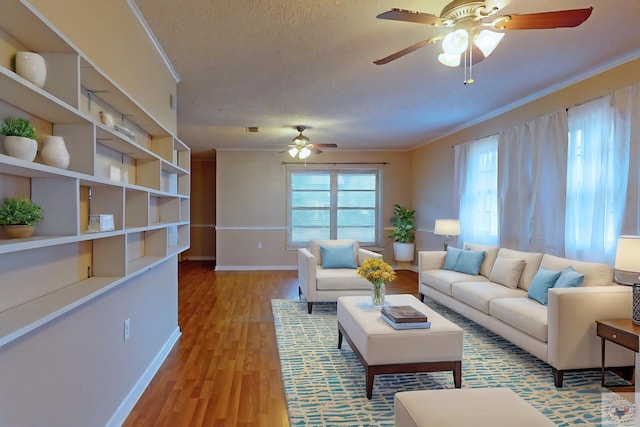 living room featuring ceiling fan, a textured ceiling, light hardwood / wood-style flooring, and crown molding