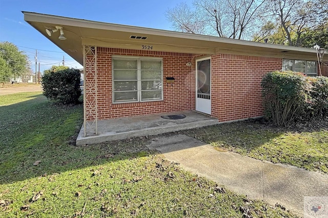 doorway to property with a yard