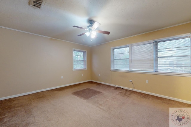 unfurnished room featuring ceiling fan, ornamental molding, and light carpet