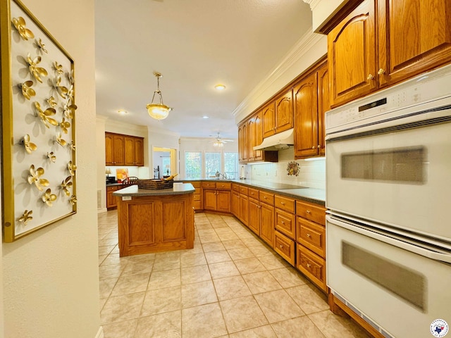 80 Tommy Hines Ln, Texarkana, TX 75501 - kitchen with brown cabinetry, double oven, crown molding, decorative backsplash, and black electric cooktop