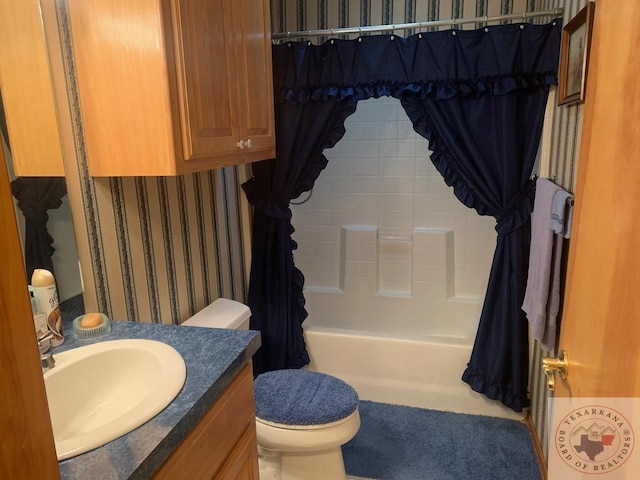 full bathroom featuring vanity, toilet, and shower / tub combo