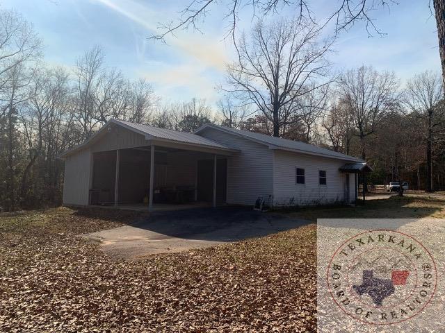 view of side of home with a carport