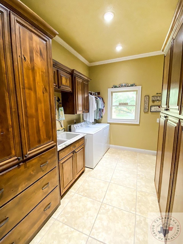 clothes washing area with light tile patterned floors, cabinets, washer and dryer, and ornamental molding