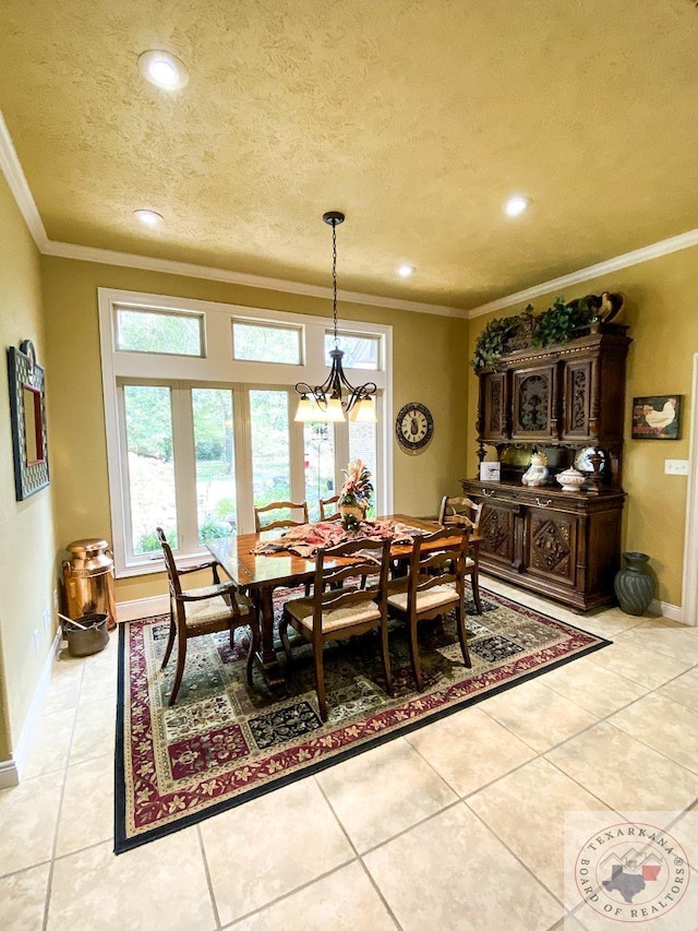 tiled dining area featuring a textured ceiling, ornamental molding, and a chandelier